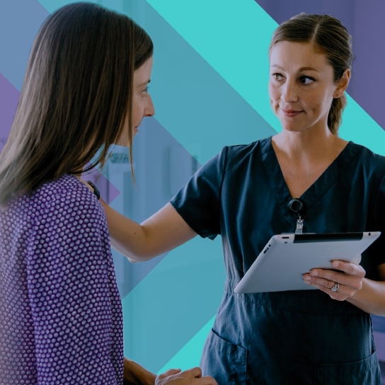 A nurse reassures a patient about the safety of contrast agents.